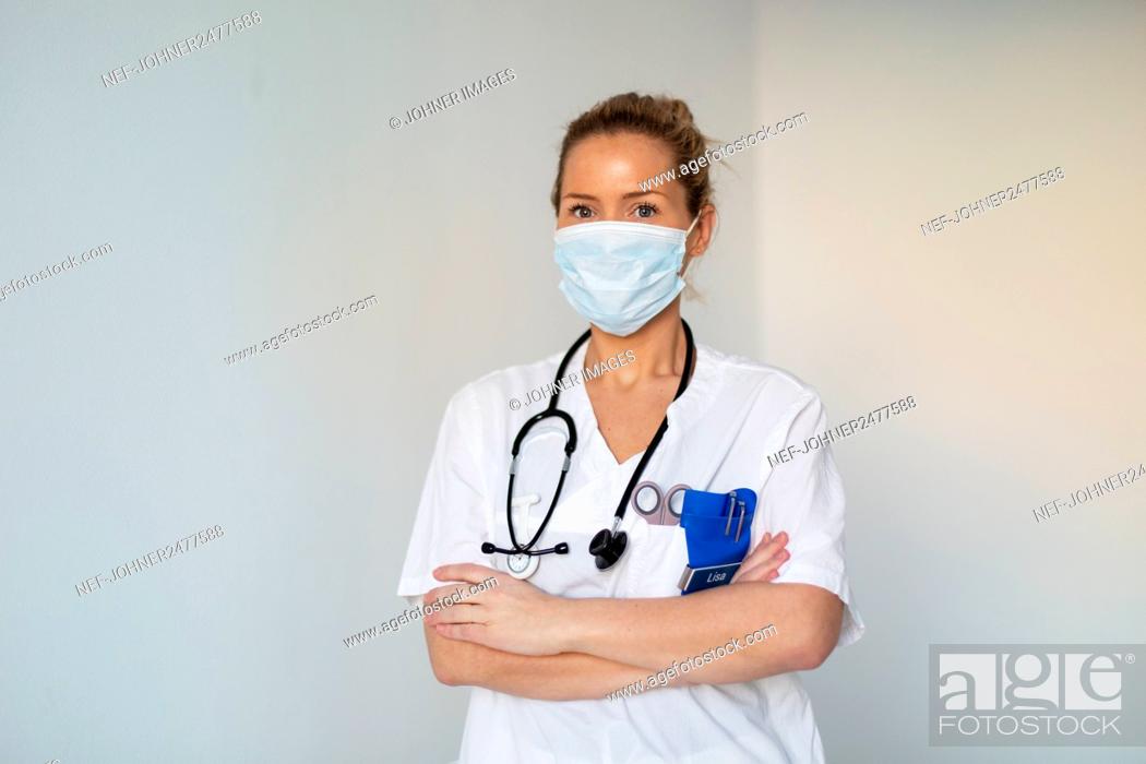Stock Photo: Female doctor wearing face mask.