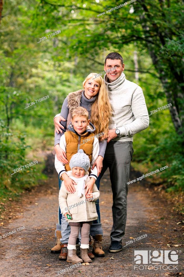 Stock Photo: Portrait of a young family in the autumn park.