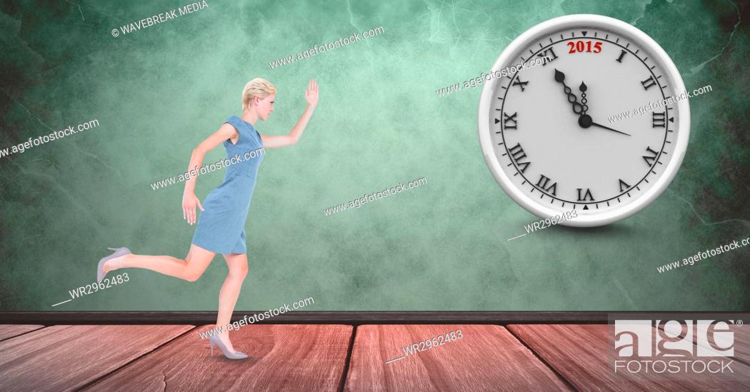 Stock Photo: Full length of businesswoman running late with clock in background.