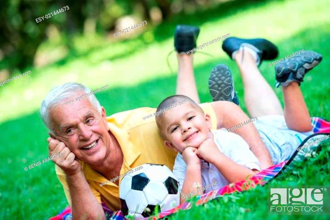 Stock Photo: grandfather and child have fun in park.