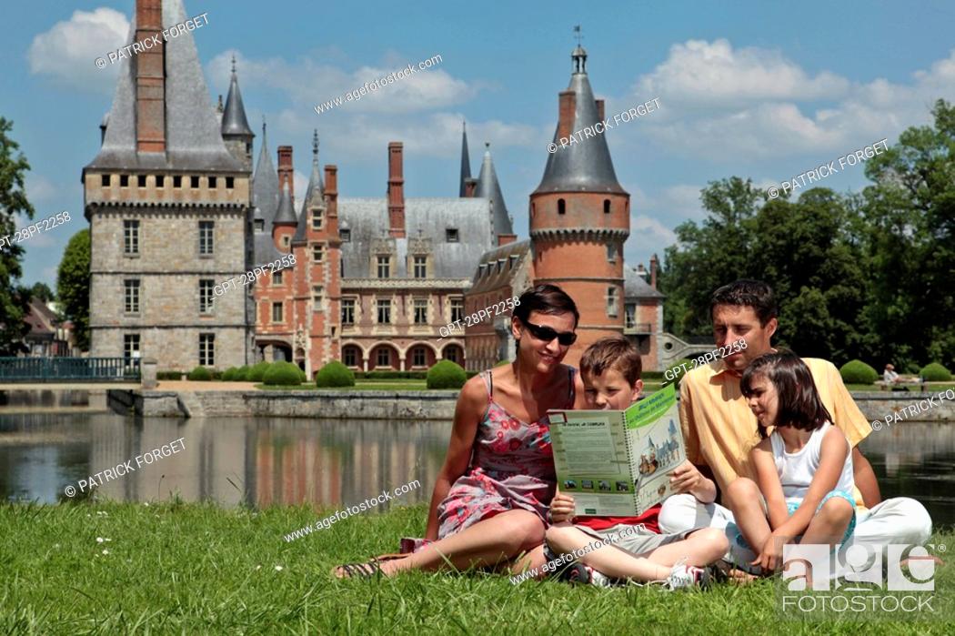 Stock Photo: FAMILY READING AND PLAYING THE GAMES IN A GUIDE BOOK ON THE HISTORY OF THE CHATEAU DE MAINTENON, EURE-ET-LOIR 28, FRANCE.