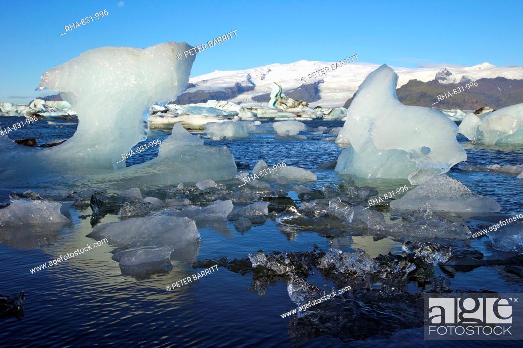 Stock Photo: Icebergs on glacial lake at Jokulsarlon with snow on the massive icecap of Vatnajokull behind, Iceland, Polar Regions.