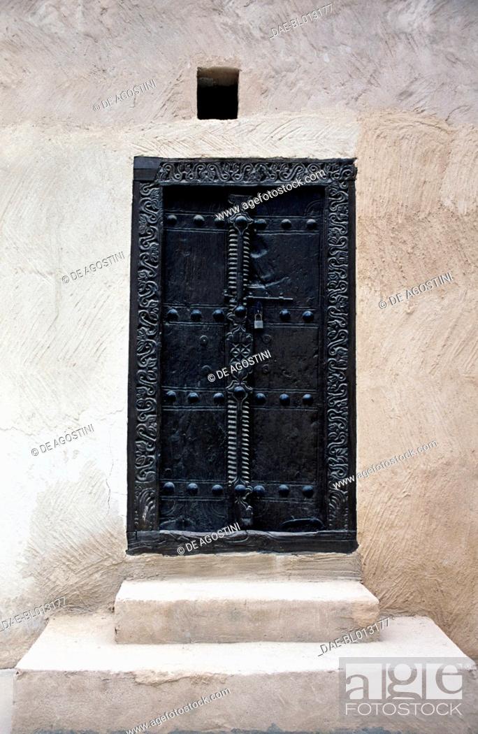 Stock Photo: Carved wooden door, Al Qasimi Fort in Ras al-Khaimah City, now the National Museum of Ras al-Khaimah, United Arab Emirates.
