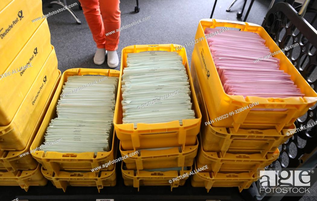 Stock Photo: 17 May 2019, Mecklenburg-Western Pomerania, Rostock: In the electoral roll and ballot by letter there are boxes with envelopes containing the completed ballot.