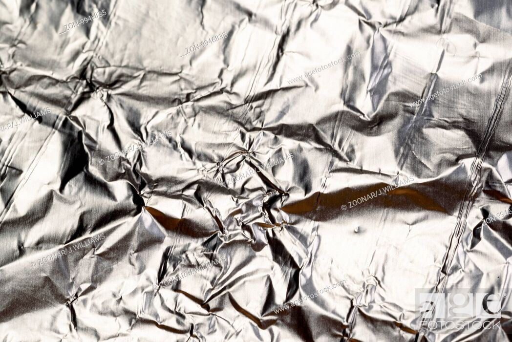 Crumpled Aluminum tin foil texture with light reflections on the shiny  metallic silver wrapping, Stock Photo, Picture And Rights Managed Image.  Pic. ZON-9946835