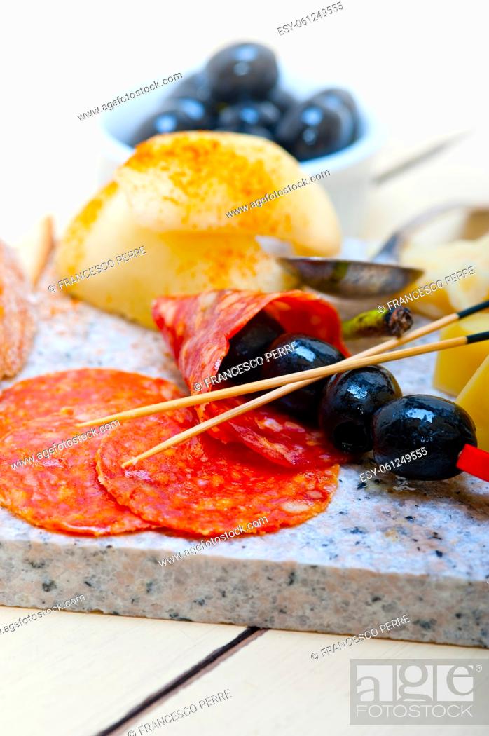 Stock Photo: cold cut assortment cheese salami and fresh pears served on a granite stone.