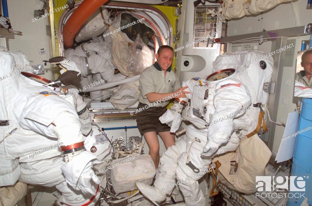 Stock Photo: Astronaut Edward M. (Mike) Fincke, Expedition 9 NASA ISS science officer and flight engineer, works with the Extravehicular Mobility Unit (EMU) spacesuits in.