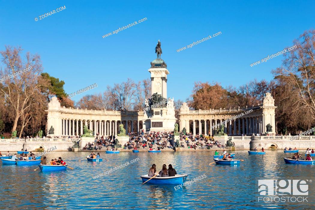 Stock Photo: Madrid, Spain - Jan 24, 2016: Tourists rowing traditional blue boats on lake in Retiro city park on a nice sunny winter day on January the 24th in Madrid, Spain.