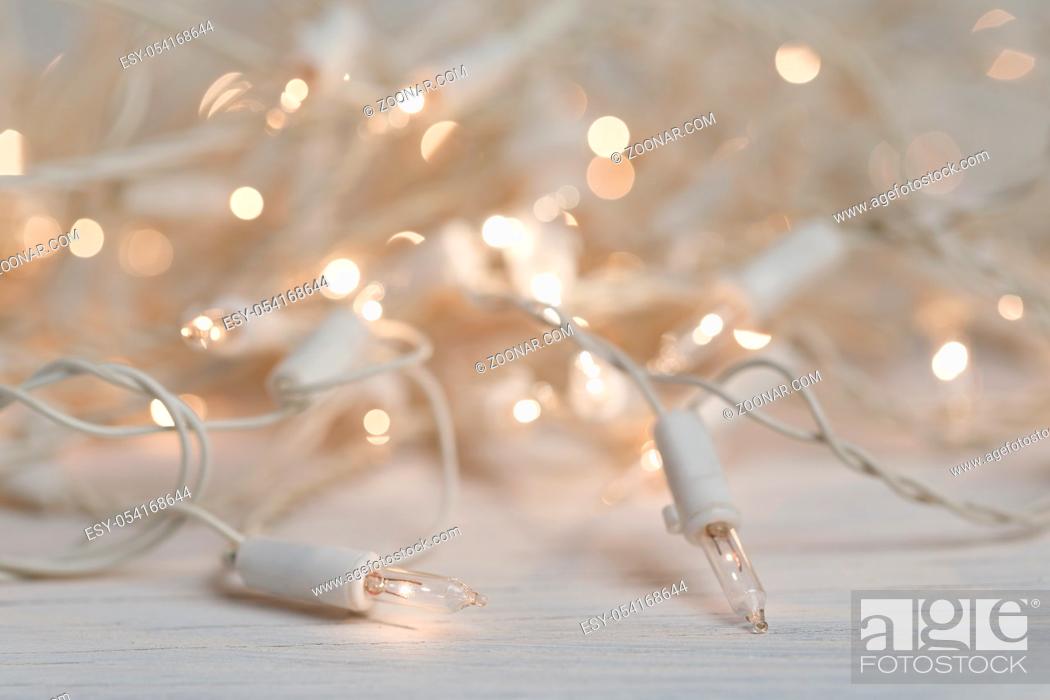 Stock Photo: white christmas lights on retro vintage wooden background with shallow focus.
