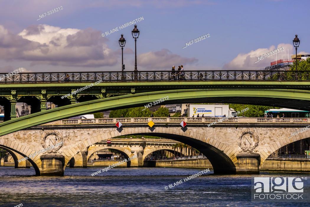 Stock Photo: Pedestrians cross Pont d'Arcole, one of the many bridges over the RIver Seine, Paris, France.