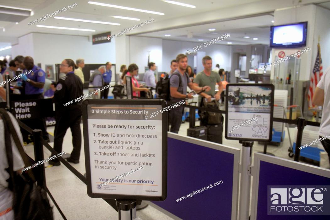 Stock Photo: Florida, Miami, Miami International Airport, MIA, security check, checkpoint, TSA, Transportation Security Administration, passengers, man, woman, sign.