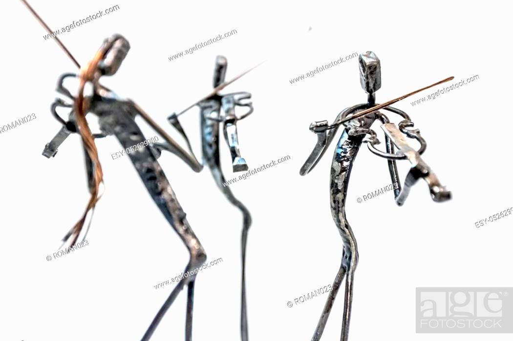 Photo de stock: Figures of music performers made with welded black metal wire, violinists are playing together living lines.