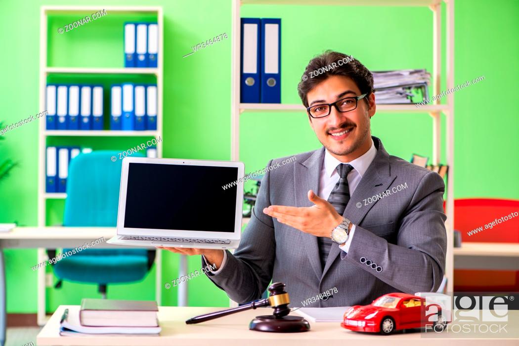Stock Photo: Young handsome lawyer working in the office.