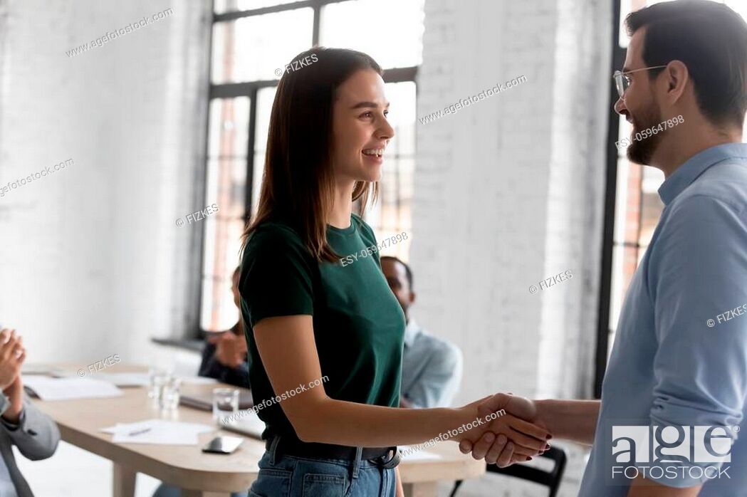 Stock Photo: Boss welcoming corporate client people gathered in boardroom start business meeting. Employee got promoted, receive praises gratitude from head during briefing.