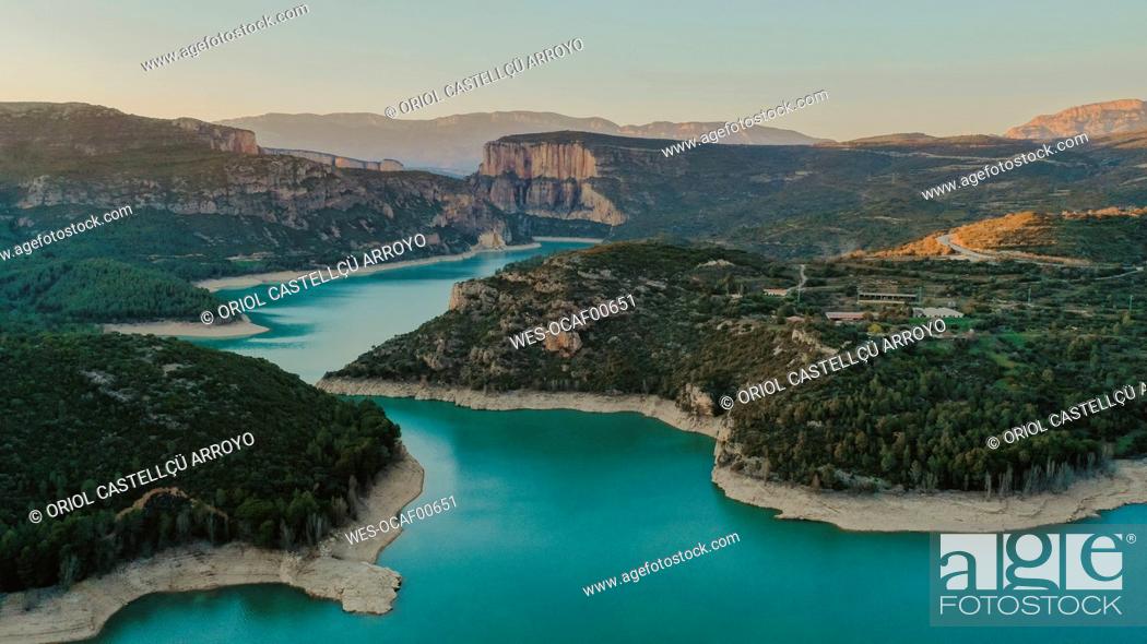 Stock Photo: Aerial view of turquoise lake surrounded by forested landscape.