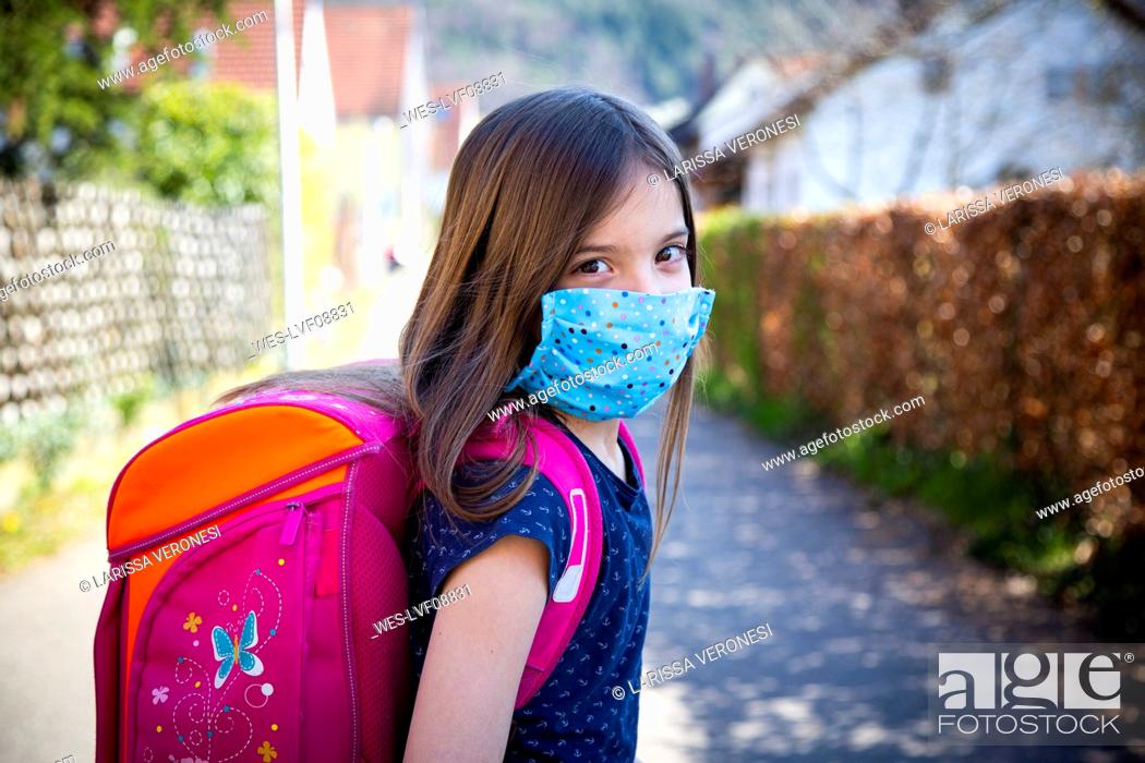 Stock Photo: Girl with homemade protective mask on her way to school.