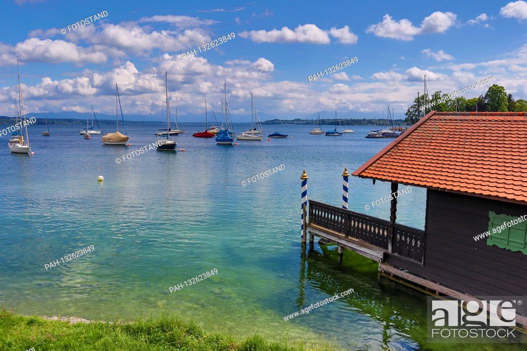 Stock Photo: Landkreis Starnberg, Germany May 25th 2020: Impressions Starnberger See - 2020 Tutzing am Starnberger See, Brahmspromenade, boat houses and sailing boats.