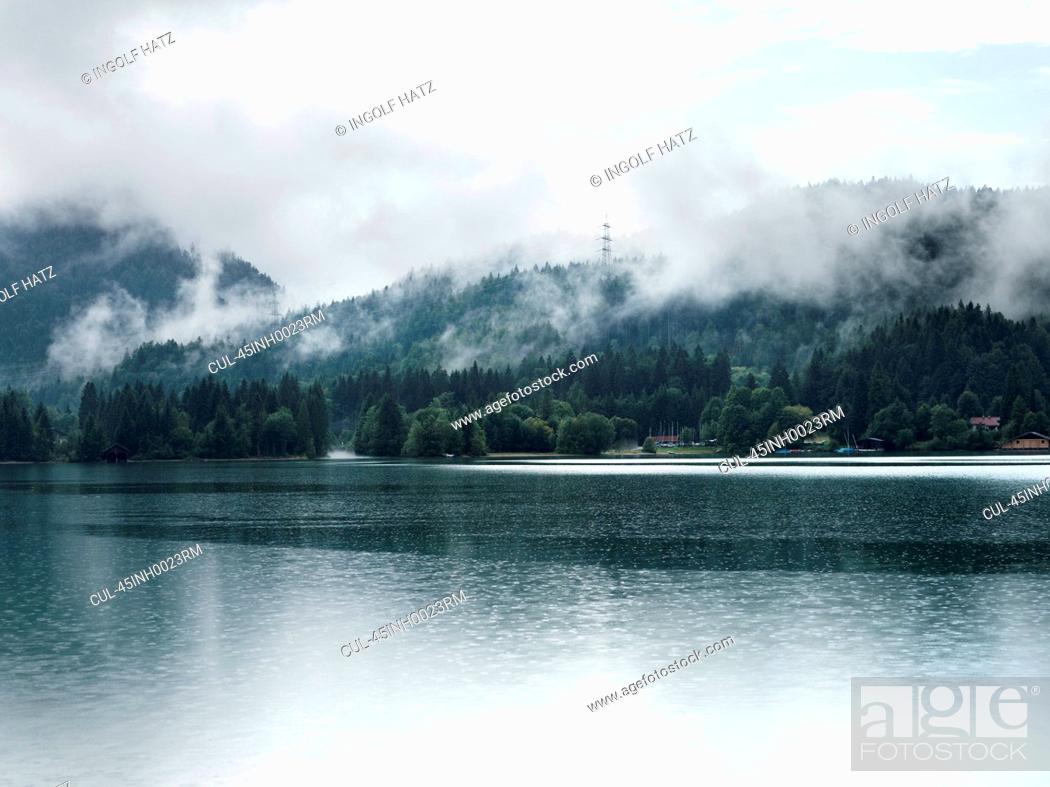 Stock Photo: Fog over mountains and still lake.