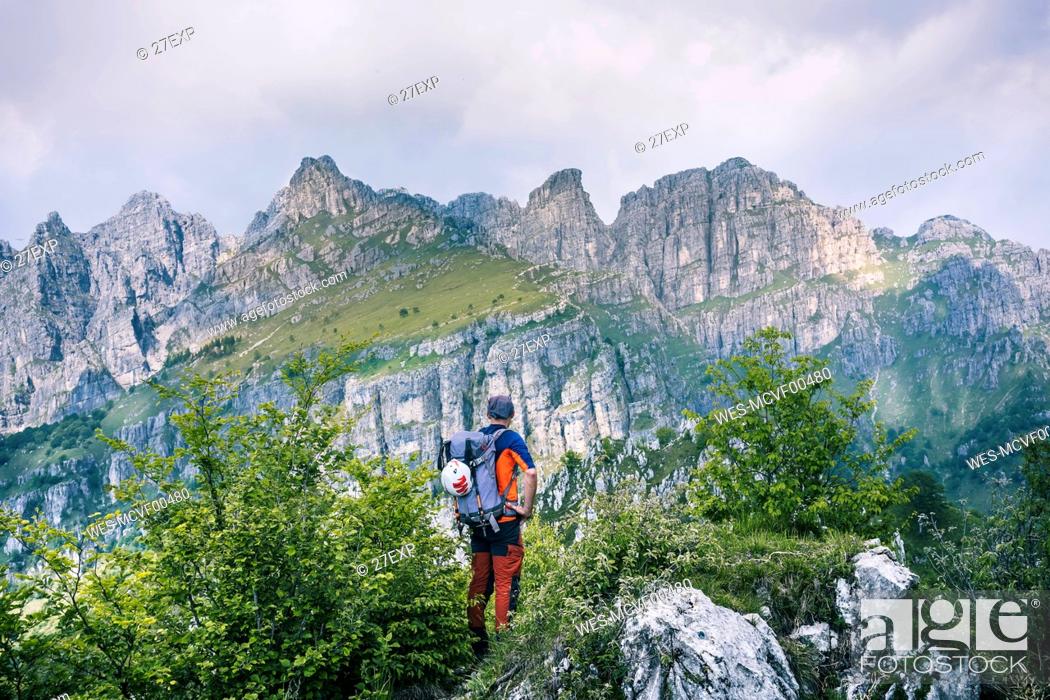 Stock Photo: Hiker standing on mountain path enjoying view, Orobie, European Alps, Como, Italy.