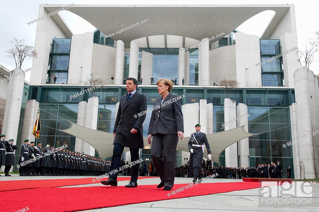 Stock Photo: New Italian Prime Minister Matteo Renzi is welcomed military honors by German Chancellor Angela Merkel (CDU) during his first official visit in front of the.