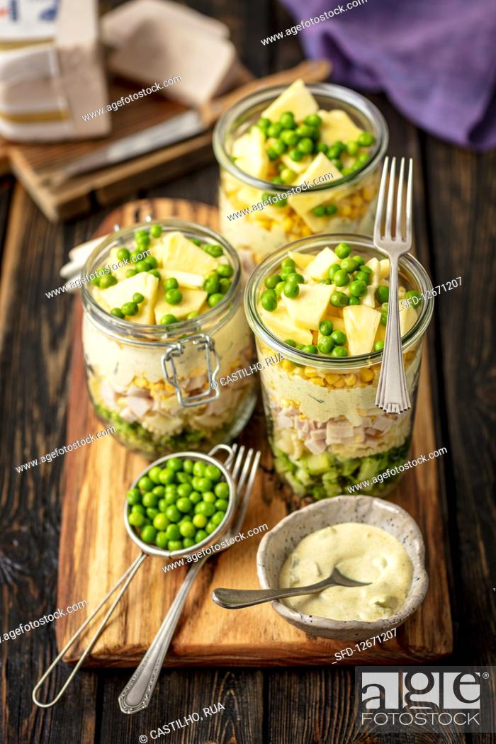 Stock Photo: Layer salad in jar - broccoli, pasta, ham, egg, sauce, corn, pineapple and green peas.