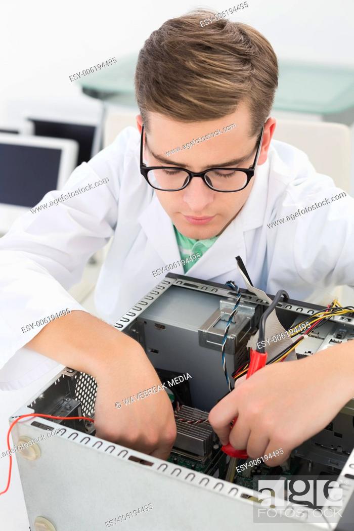 Stock Photo: Technician working on broken cpu with soldering iron.