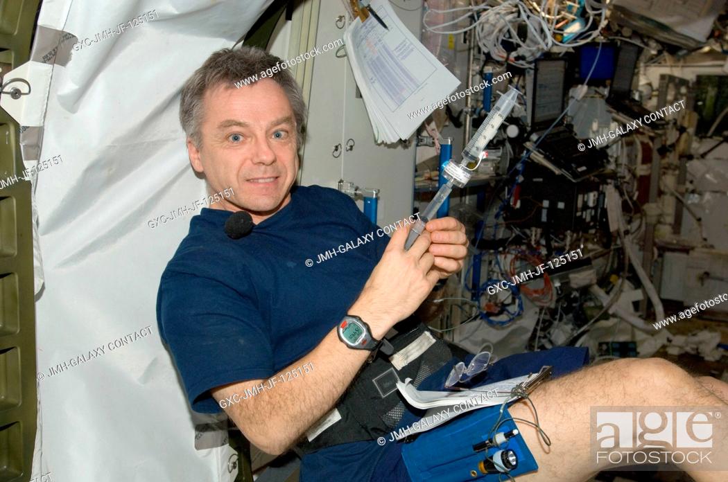 Stock Photo: Canadian Space Agency astronaut Robert Thirsk, Expedition 20 flight engineer, performs a subsequent in-flight analysis with a Water Microbiology KitMicrobial.