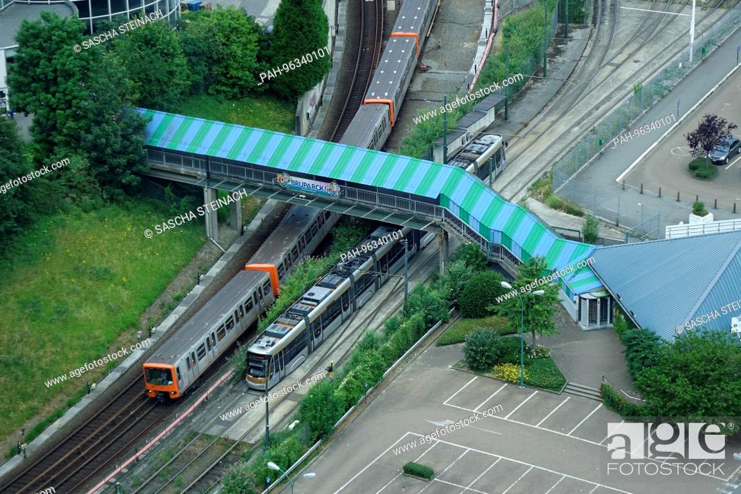 Stock Photo: A train of the Brussels Metro going under a pedestrian bridge on the Little Ring, which was completed in 2009, near Heysel Station in the Belgian captial.