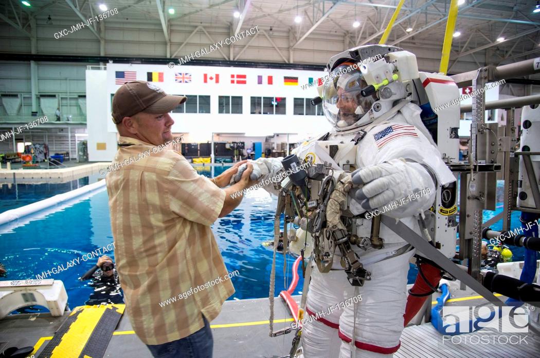 Stock Photo: NASA astronaut Reid Wiseman, Expedition 4041 flight engineer, is pictured with a crew instructor during final preparations for a spacewalk training session in.
