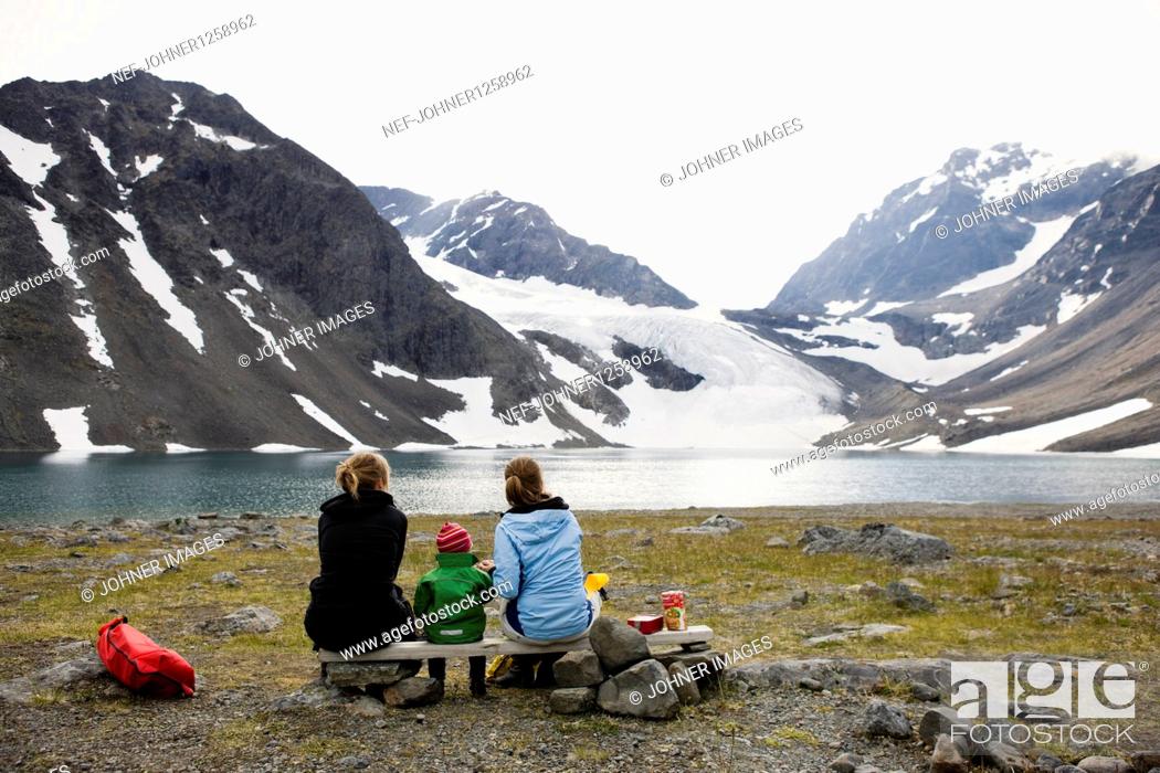 Stock Photo: Two women with baby looking at view.