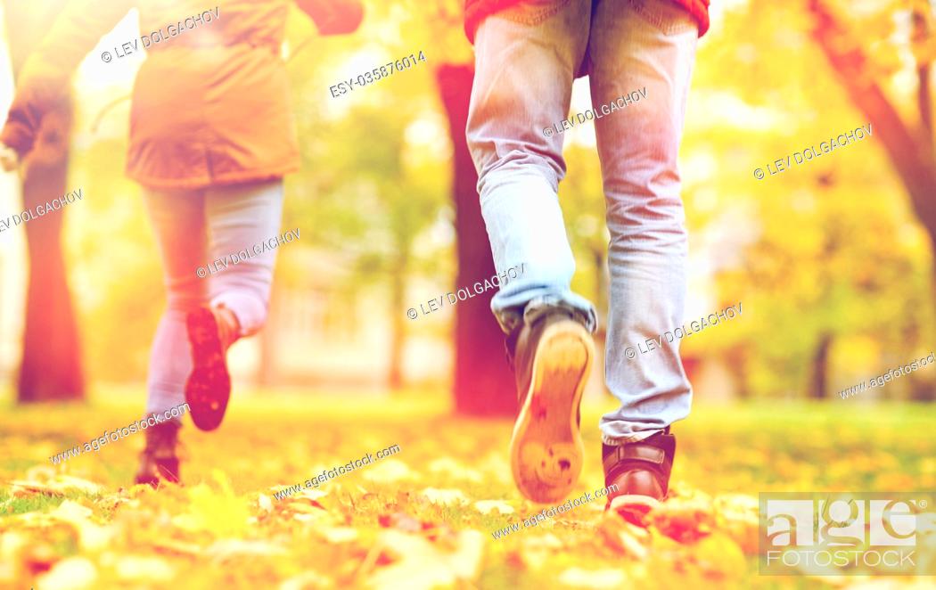 Stock Photo: young couple running in autumn park.