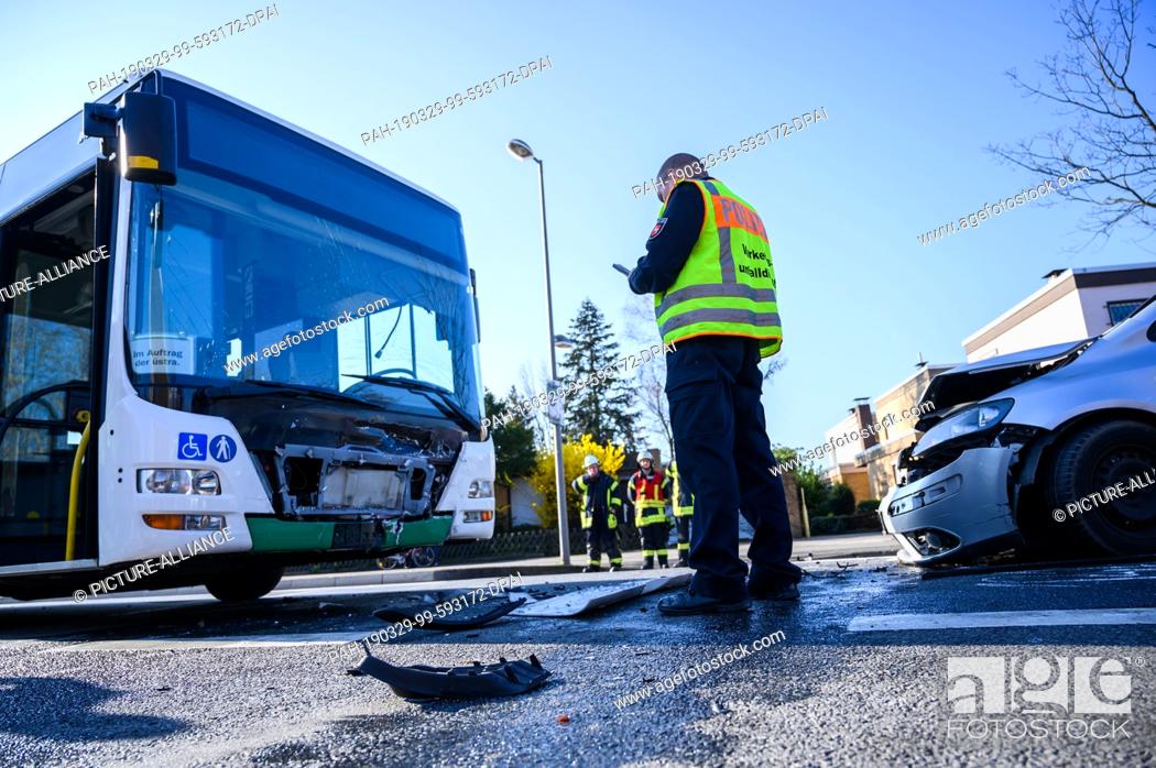Stock Photo: 29 March 2019, Lower Saxony, Garbsen: A damaged school bus and a car are at the scene of an accident. Four people were seriously injured in a collision between.