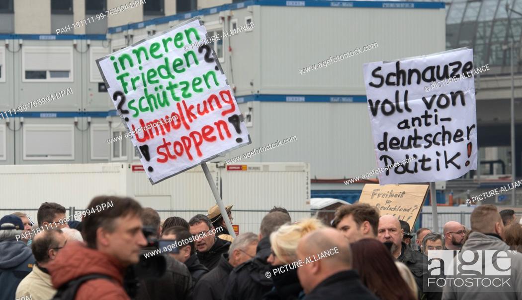 Stock Photo: 11 November 2018, Berlin: Several hundred people are pulling flags and posters at the demonstration ""No to the Compact for Migration.