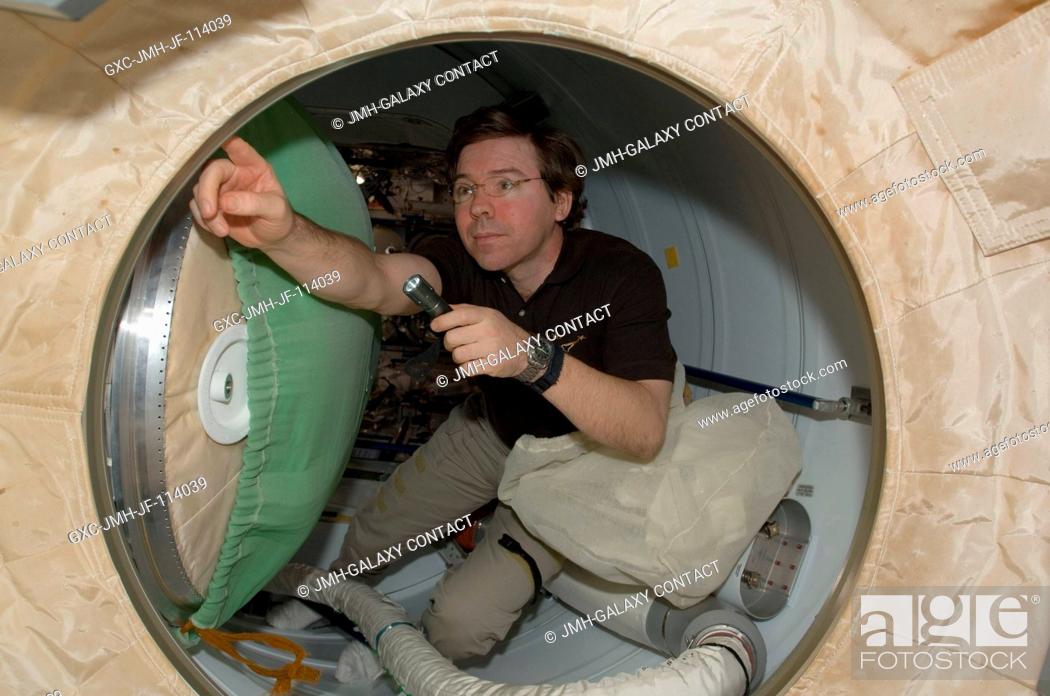 Stock Photo: NASA astronaut Michael Barratt, Expedition 20 flight engineer, works in the hatch between Space Shuttle Endeavour and the International Space Station during.