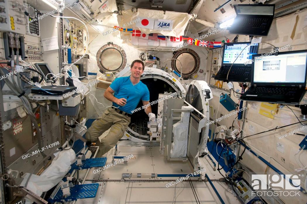 Stock Photo: ESA (European Space Agency) astronaut Thomas Pesquet floats next to the airlock inside the Japanese Experiment Module aboard the International Space Station.