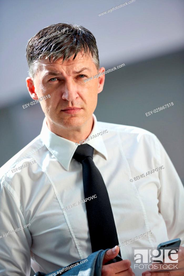 Stock Photo: business man using phone at modern office space.