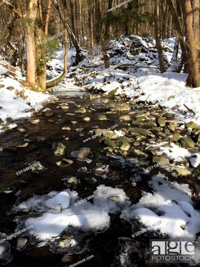 Stock Photo: a small river or even in the forest in winter with lots of snow and ice.