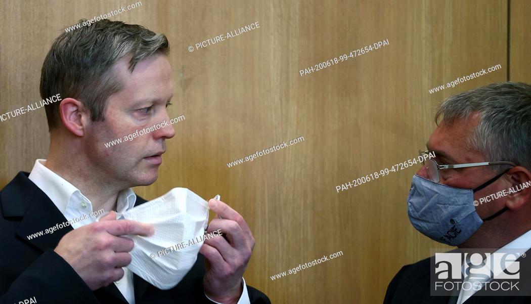 Stock Photo: 18 June 2020, Hessen, Frankfurt/Main: Stephan Ernst (l), who is accused of the murder of the politician Lübcke, talks to his lawyer Frank Henning (r) in the.