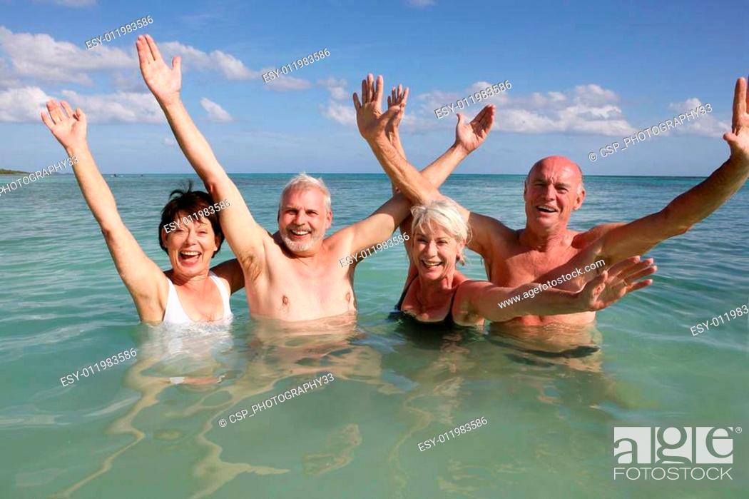 Stock Photo: Retired people swimming in the ocean.