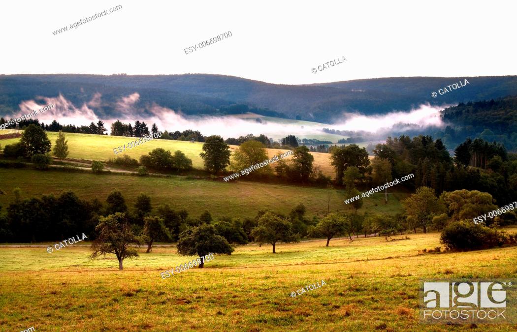 Stock Photo: fog in mountains at early morning before sunrise in Bavaria.
