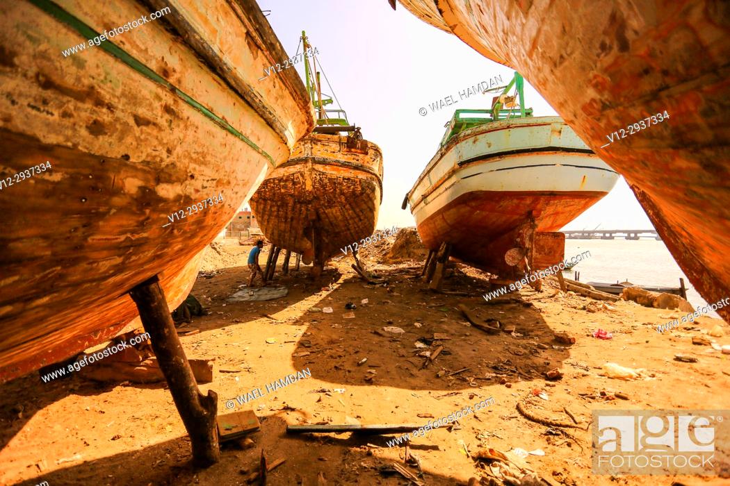 Stock Photo: Painting work on new wooden boats on a dry dock, El-Burullos, Kafr El-Sheikh, Egypt, Africa.