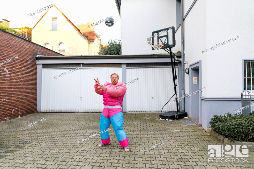 Stock Photo: Portrait of a man with basketball wearing pink bodybuilder costume.