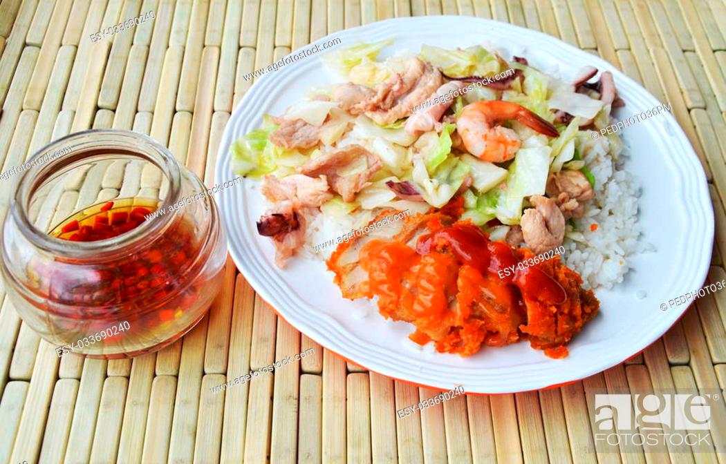 Stock Photo: stir fried cabbage with seafood and crispy chicken on rice.