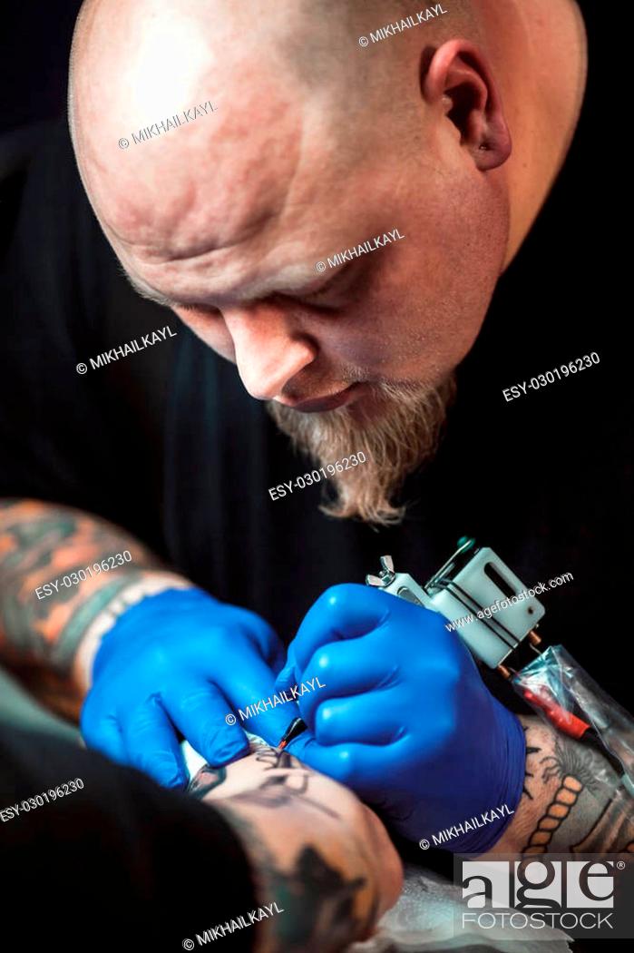 master tattoo artist with a beard makes gloves tattoo on hand men, Stock  Photo, Picture And Low Budget Royalty Free Image. Pic. ESY-030196230 |  agefotostock