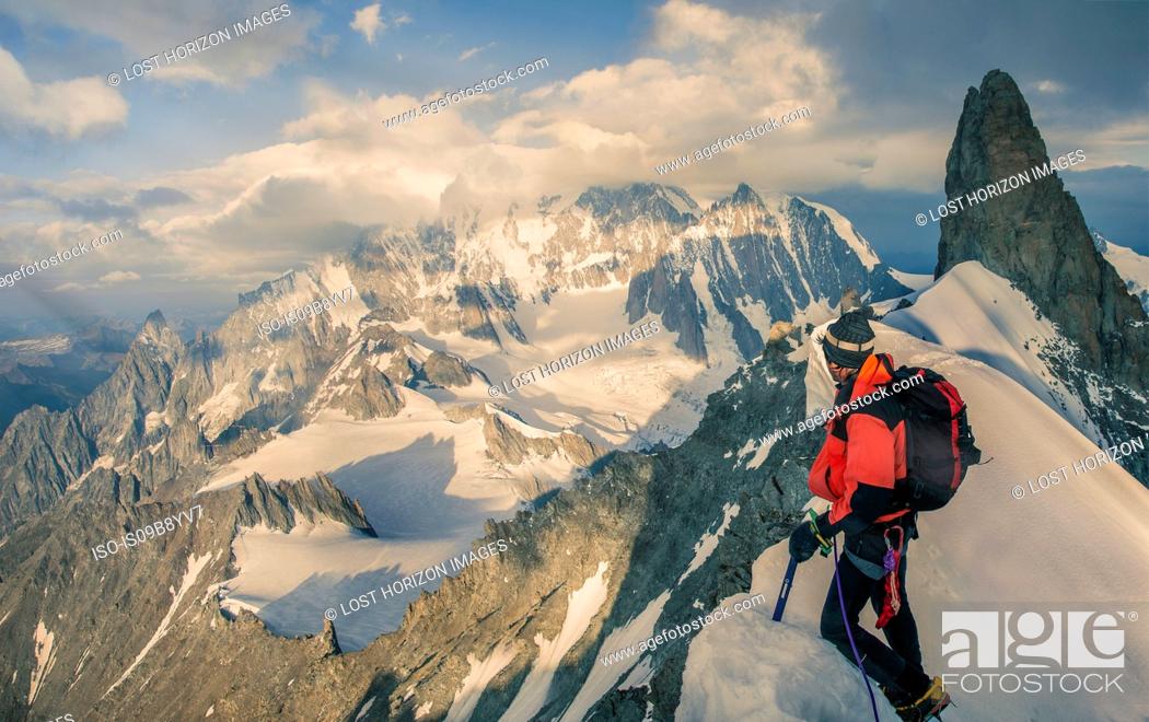 Stock Photo: Mountain climber on the Rochefort Ridge looking at Mont Blanc, Courmayeur, Aosta Valley, Italy, Europe.