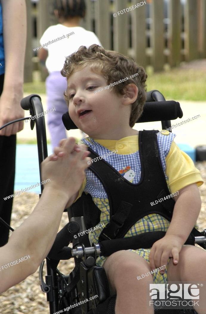 Stock Photo: A tender moment in the life of a child with severe disabilities.
