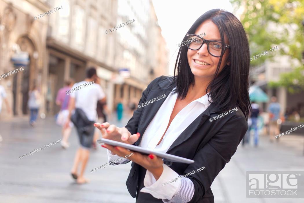 Stock Photo: Smiling Businesswoman Using Tablet Computer on street, Business woman.