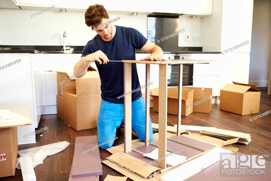 Stock Photo: Man Putting Together Self Assembly Furniture In New Home.