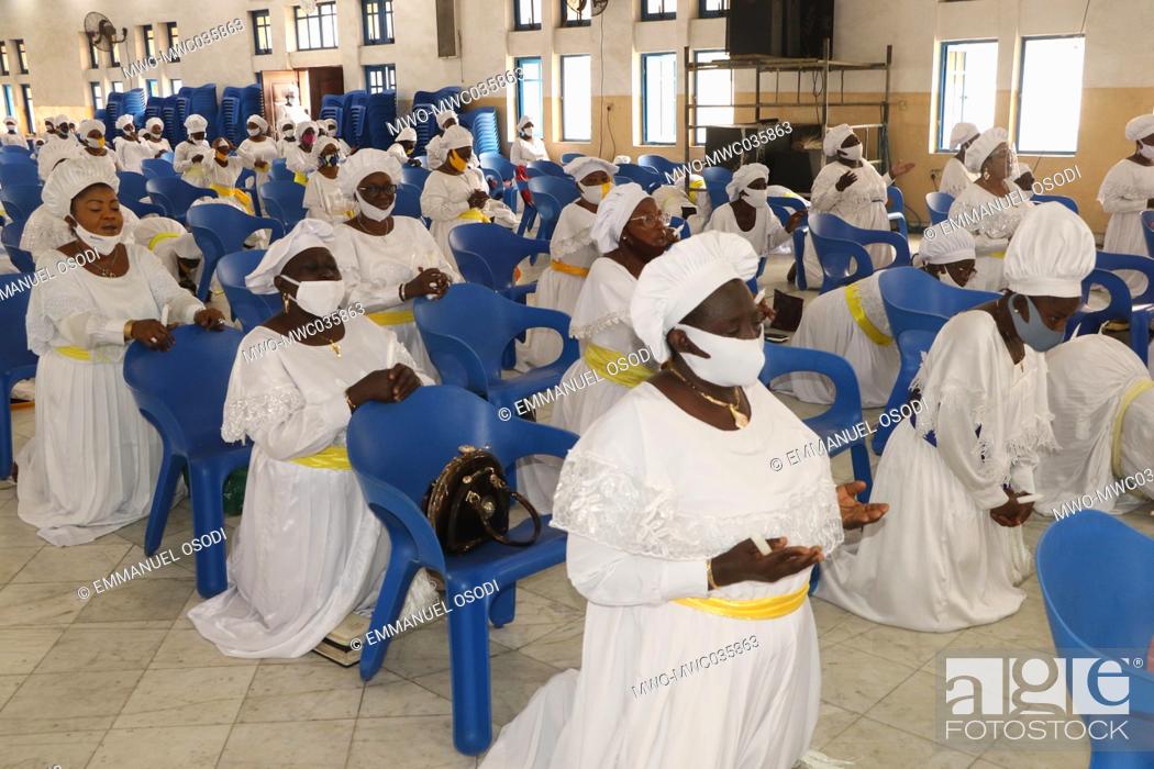 Stock Photo: Christian faithful wearing face mask and maintaining social distancing gather to make praises to God at Lagos Presbyterian church.