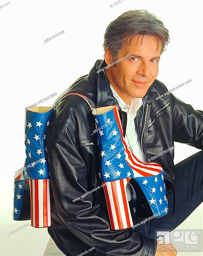 Stock Photo: Italian song writer Claudio Baglioni (Claudio Enrico Paolo Baglioni) posing with American wedge-boots on his shoulder for a photo shoot for TV show 'Anima mia'.